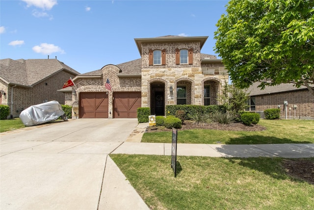 813 Pier St, Little Elm, TX 76227 - french provincial home featuring a garage, a front yard, concrete driveway, stone siding, and brick siding