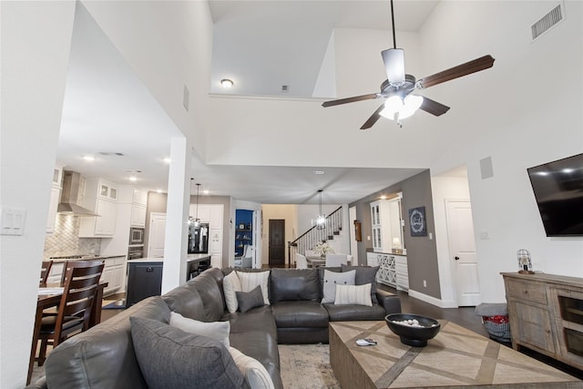 813 Pier St, Little Elm, TX 76227 - living area featuring stairway, ceiling fan, a high ceiling, and baseboards
