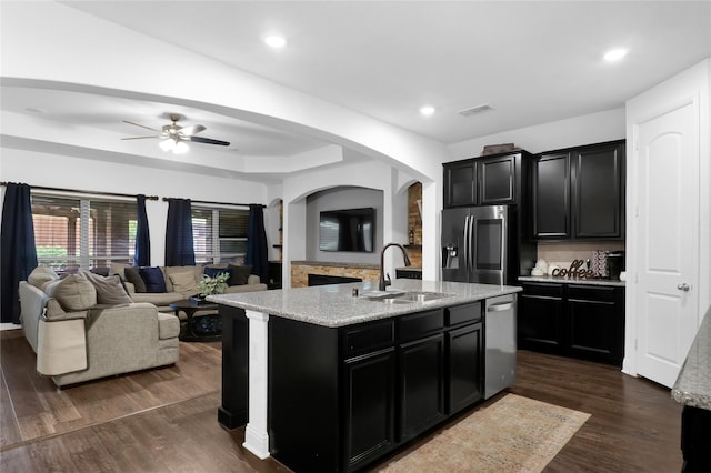 14649 Martin Creek Cv, Fort Worth, TX 76262 - kitchen with stainless steel appliances, a sink, dark cabinetry, open floor plan, and recessed lighting