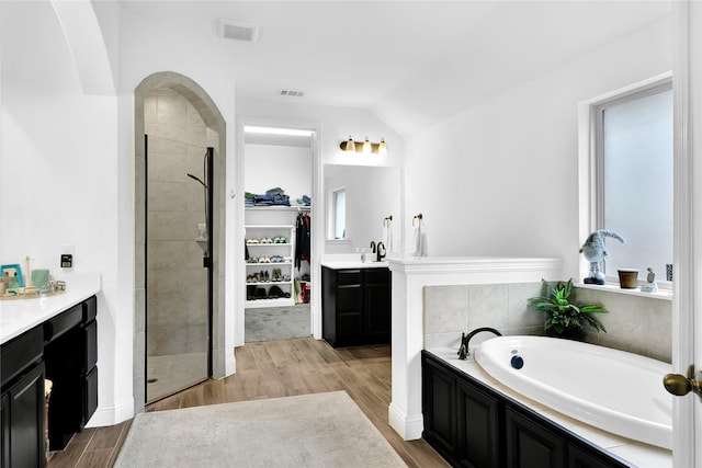 14649 Martin Creek Cv, Fort Worth, TX 76262 - bathroom featuring vanity, a stall shower, a garden tub, wood finished floors, and lofted ceiling