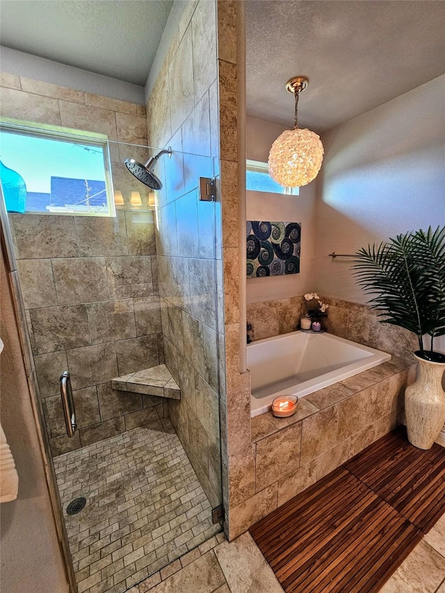 4805 Saddleback Ln, Wichita Falls, TX 73608 - bathroom featuring a stall shower, a bath, a textured ceiling, and a chandelier