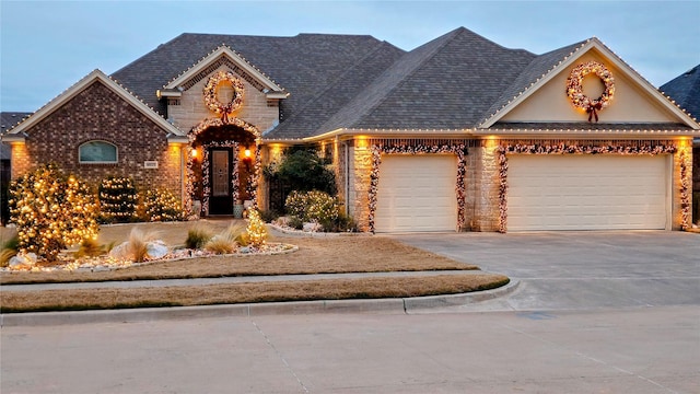 4805 Saddleback Ln, Wichita Falls, TX 73608 - view of front facade featuring an attached garage, driveway, and stone siding