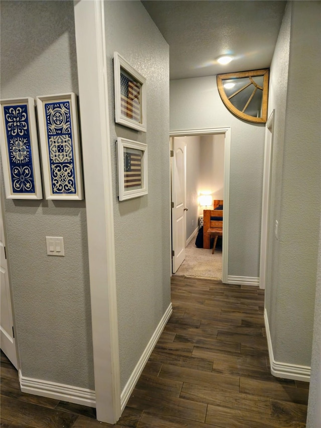 4805 Saddleback Ln, Wichita Falls, TX 73608 - hallway featuring dark wood finished floors, baseboards, and a textured wall