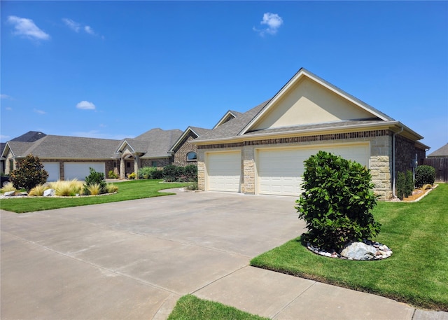 4805 Saddleback Ln, Wichita Falls, TX 73608 - view of front of property with a front lawn, stone siding, driveway, and a garage