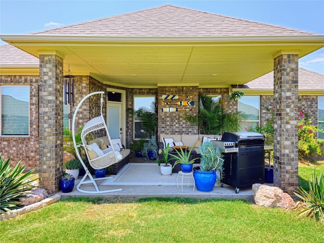 4805 Saddleback Ln, Wichita Falls, TX 73608 - entrance to property with a shingled roof, a patio area, brick siding, and a lawn