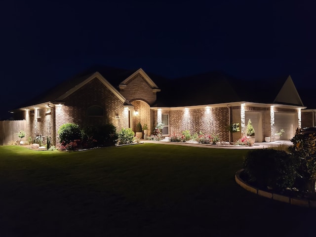4805 Saddleback Ln, Wichita Falls, TX 73608 - view of front of home with a garage, brick siding, and a lawn