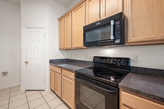 8329 Rolling Rock Dr, Fort Worth, TX 76123 - kitchen featuring light tile patterned flooring, light brown cabinetry, black appliances, and dark countertops