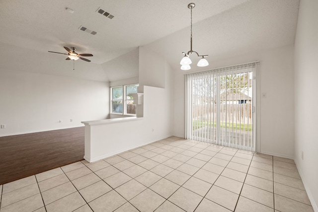 8329 Rolling Rock Dr, Fort Worth, TX 76123 - spare room with ceiling fan with notable chandelier, lofted ceiling, light tile patterned flooring, and visible vents
