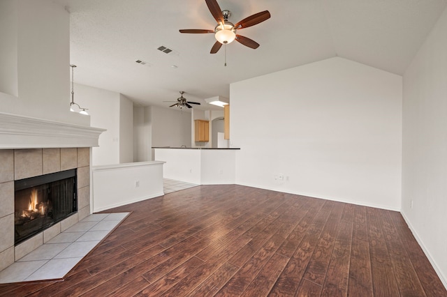 8329 Rolling Rock Dr, Fort Worth, TX 76123 - unfurnished living room with visible vents, wood finished floors, a fireplace, a ceiling fan, and vaulted ceiling