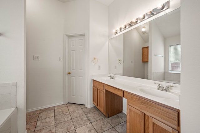 8329 Rolling Rock Dr, Fort Worth, TX 76123 - bathroom featuring double vanity, baseboards, a sink, and a bath