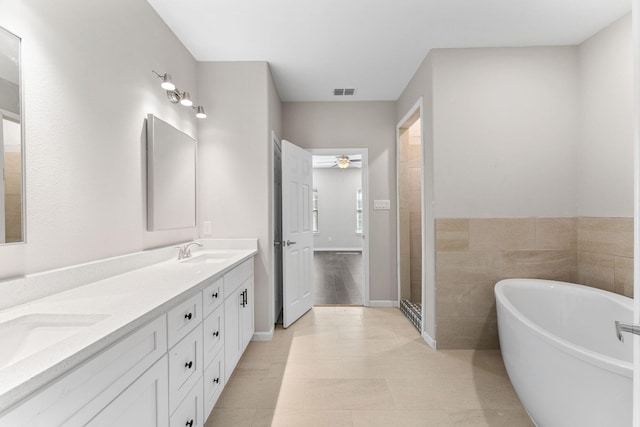 3504 Keyridge Dr, Dallas, TX 75241 - bathroom featuring a soaking tub, double vanity, ceiling fan, and a walk in shower