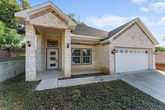 3504 Keyridge Dr, Dallas, TX 75241 - view of front of house featuring stone siding, concrete driveway, an attached garage, and brick siding