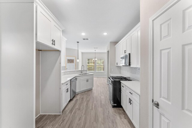 3504 Keyridge Dr, Dallas, TX 75241 - kitchen with stainless steel dishwasher, a sink, a peninsula, backsplash, and white cabinets