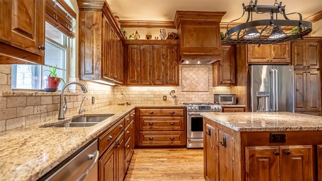 169 Star Point Ln, Weatherford, TX 76088 - kitchen with light wood-style flooring, brown cabinets, stainless steel appliances, a sink, and light stone counters