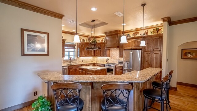 169 Star Point Ln, Weatherford, TX 76088 - kitchen with ornamental molding, stainless steel appliances, tasteful backsplash, and a large island