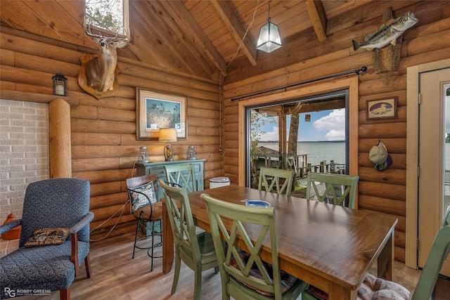 dining room with light wood-style floors, wooden ceiling, lofted ceiling with beams, and log walls
