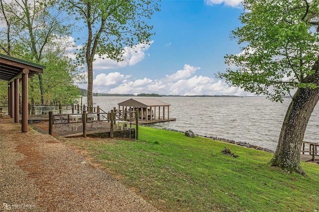 view of dock featuring a water view and a lawn