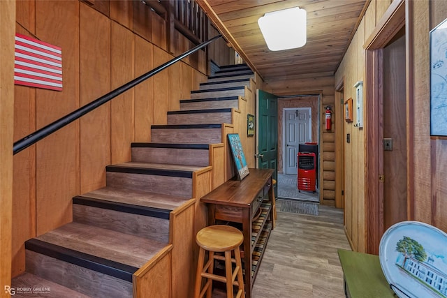 staircase with wooden ceiling and wood finished floors