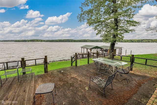 exterior space with a yard, fence, and a water view