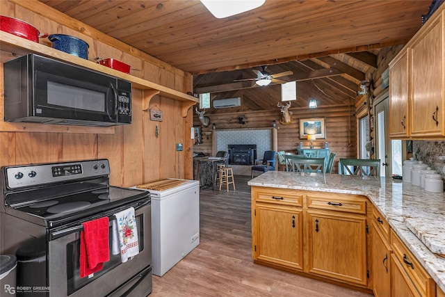 kitchen with stainless steel electric range oven, lofted ceiling with beams, a peninsula, black microwave, and light wood-style flooring