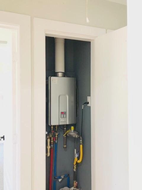 10503 Cayuga Dr, Dallas, TX 75228 - utility room featuring tankless water heater
