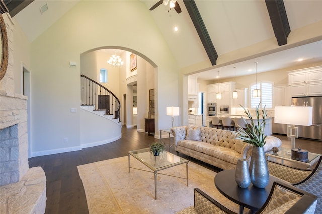 2813 Maverick Way, Celina, TX 75009 - living area featuring arched walkways, high vaulted ceiling, dark wood-style floors, a ceiling fan, and stairs
