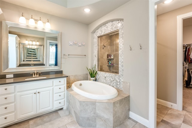 2813 Maverick Way, Celina, TX 75009 - bathroom featuring a bath, vanity, tile patterned floors, a walk in closet, and recessed lighting