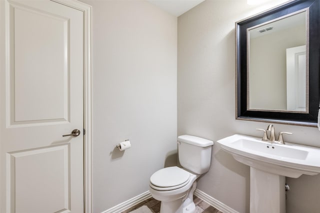 2813 Maverick Way, Celina, TX 75009 - half bathroom with toilet, baseboards, and wood finished floors