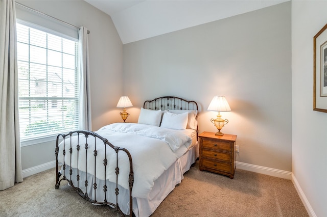 2813 Maverick Way, Celina, TX 75009 - bedroom featuring multiple windows, vaulted ceiling, light carpet, and baseboards