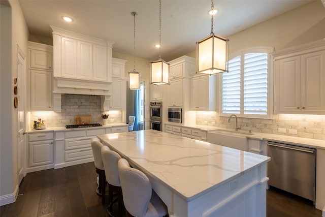 2813 Maverick Way, Celina, TX 75009 - kitchen with a sink, appliances with stainless steel finishes, white cabinets, light stone countertops, and dark wood finished floors