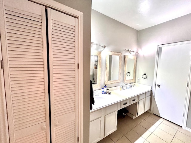 full bath with tile patterned floors, a closet, and double vanity