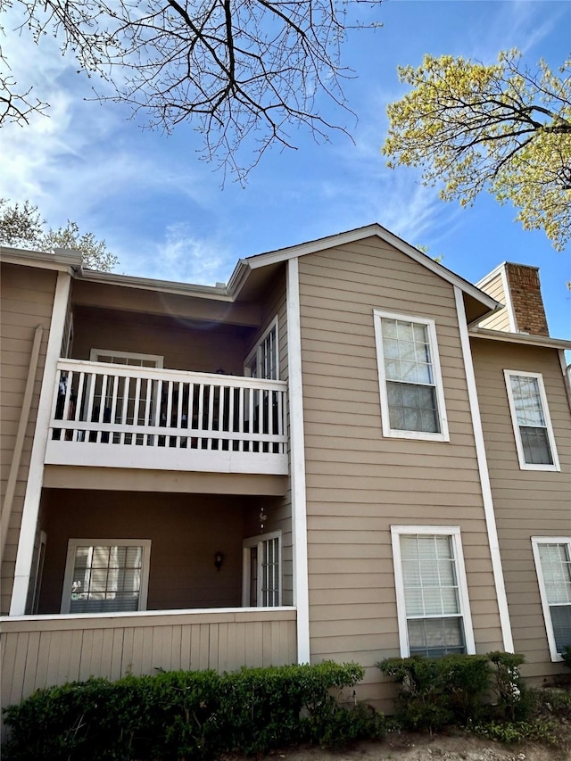 view of side of property with a balcony