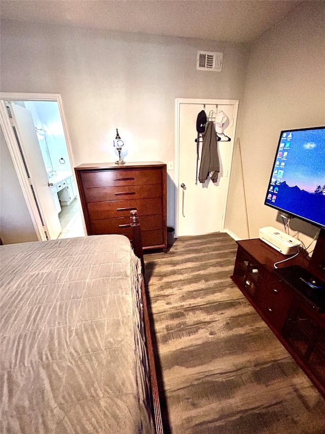 bedroom with visible vents and ensuite bathroom