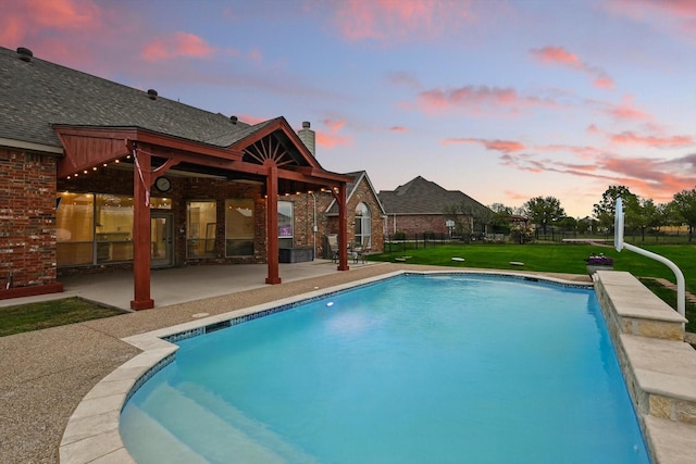 809 Chiswick Ct, Haslet, TX 76052 - pool at dusk with a patio, a yard, and an outdoor pool