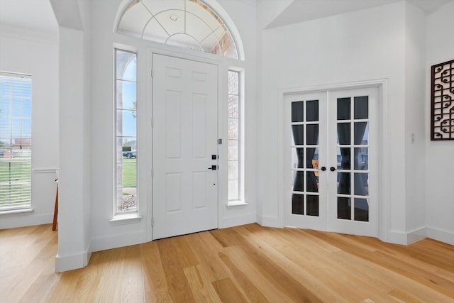 809 Chiswick Ct, Haslet, TX 76052 - entrance foyer featuring light wood finished floors, french doors, and baseboards