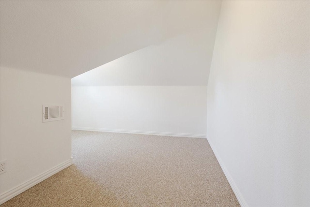 bonus room featuring baseboards, vaulted ceiling, visible vents, and carpet