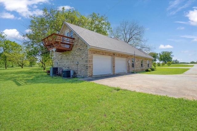 view of property exterior featuring driveway, central AC, an attached garage, a lawn, and a deck
