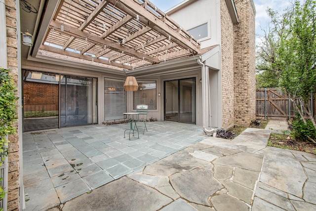 view of patio featuring fence and a pergola
