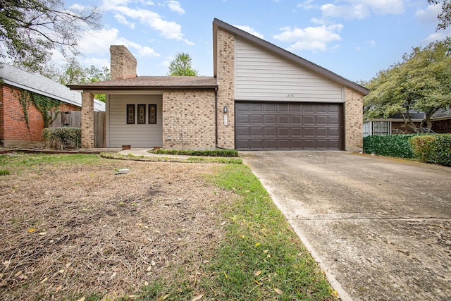 exterior space with a garage, brick siding, a chimney, and concrete driveway