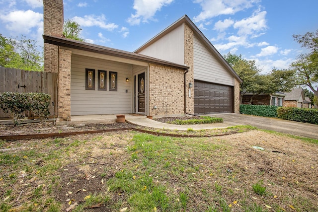 mid-century inspired home with brick siding, a garage, concrete driveway, and fence