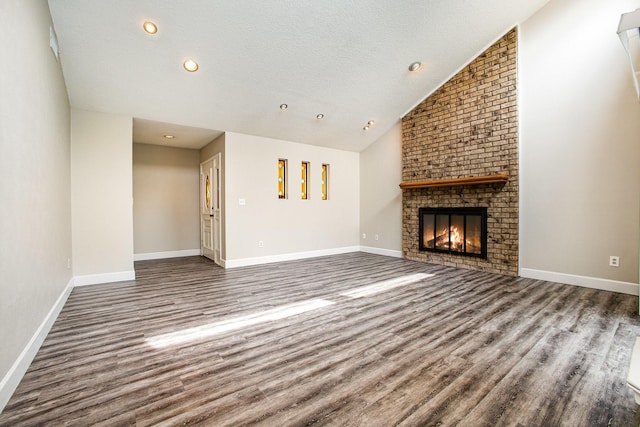unfurnished living room with baseboards, wood finished floors, and a fireplace