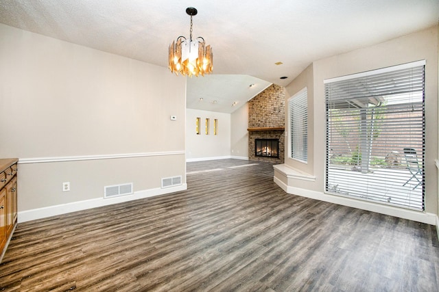 unfurnished living room featuring baseboards, dark wood-style flooring, a brick fireplace, and visible vents