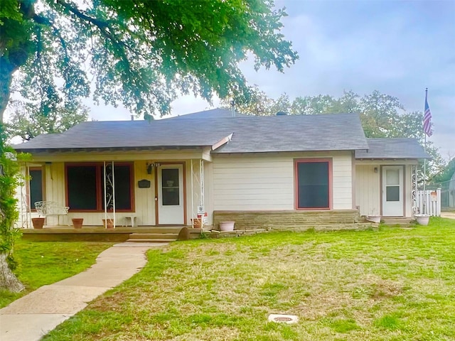 4735 Panola Ave, Fort Worth, TX 76103 - ranch-style home featuring stone siding, a front lawn, and a porch