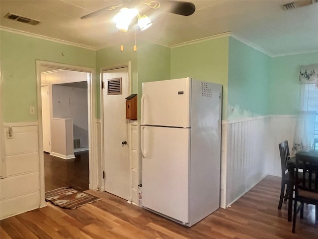 4735 Panola Ave, Fort Worth, TX 76103 - kitchen with a wainscoted wall, visible vents, a ceiling fan, and freestanding refrigerator
