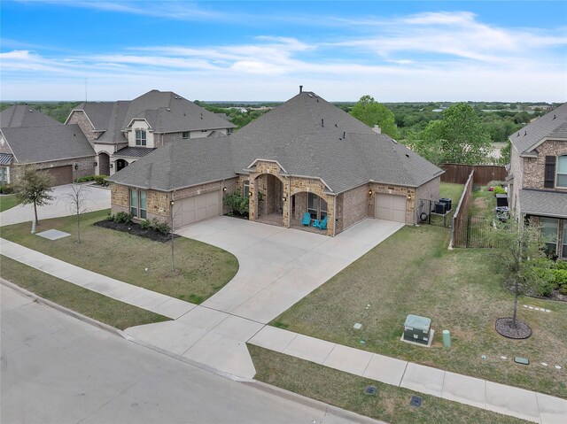9857 La Frontera Dr, Fort Worth, TX 76179 - view of front of home with a garage, concrete driveway, brick siding, and a shingled roof