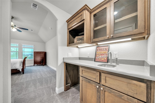 bar with vaulted ceiling, a sink, light colored carpet, wet bar, and visible vents