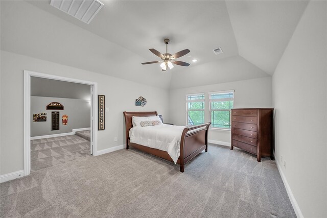 carpeted bedroom with ceiling fan, vaulted ceiling, visible vents, and baseboards