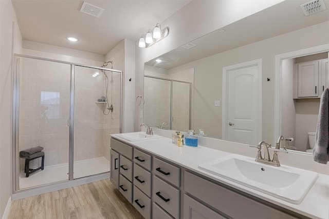 2728 Baneberry Ln, Mesquite, TX 75150 - full bathroom featuring a shower stall, wood finished floors, double vanity, recessed lighting, and toilet