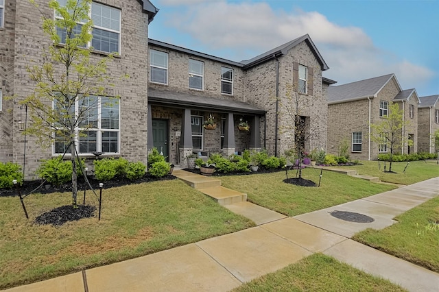 2728 Baneberry Ln, Mesquite, TX 75150 - view of front of property featuring covered porch, a front yard, and brick siding