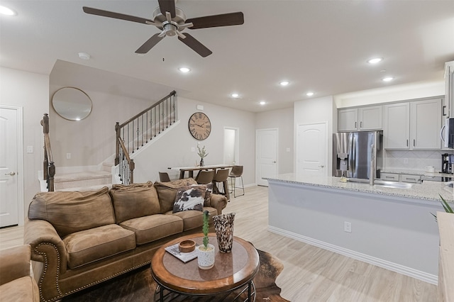 2728 Baneberry Ln, Mesquite, TX 75150 - living room with stairway, light wood-style flooring, a ceiling fan, recessed lighting, and baseboards